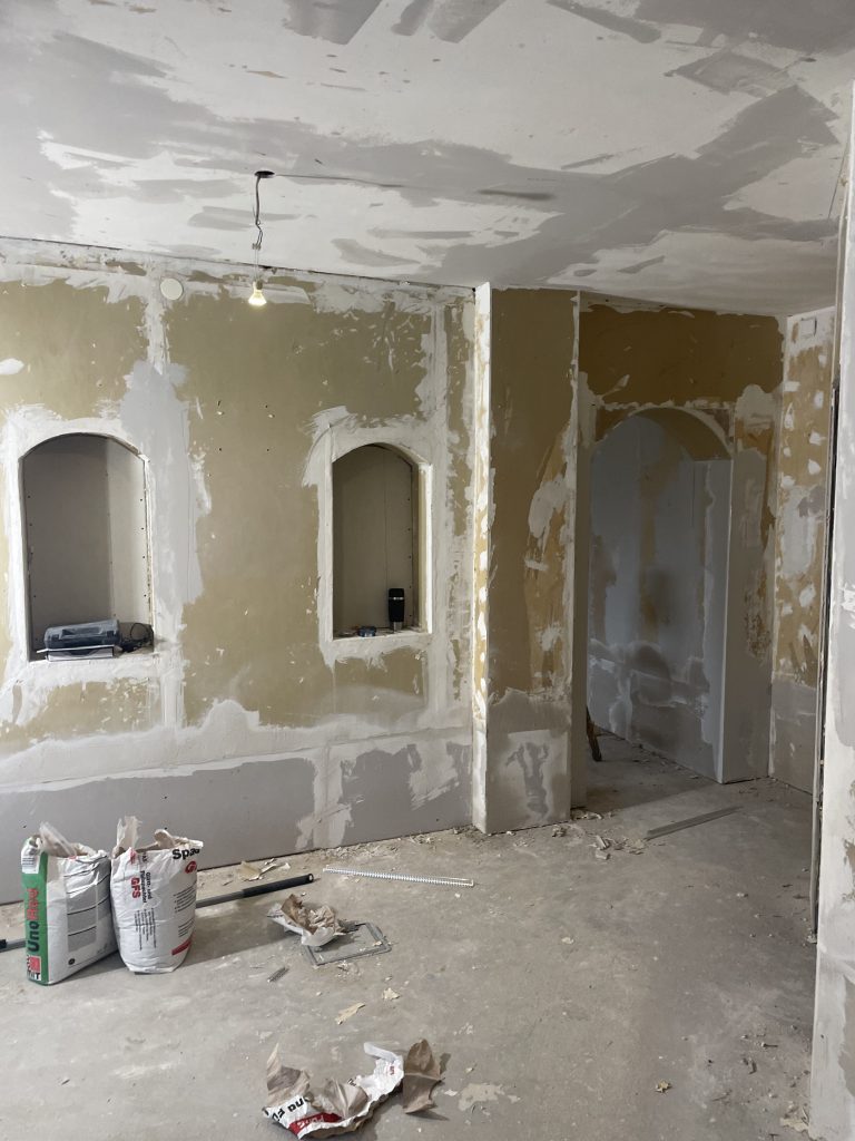 Vorherbild einer Altbausanierung mit historischem Torbogen – vor der Sanierung.