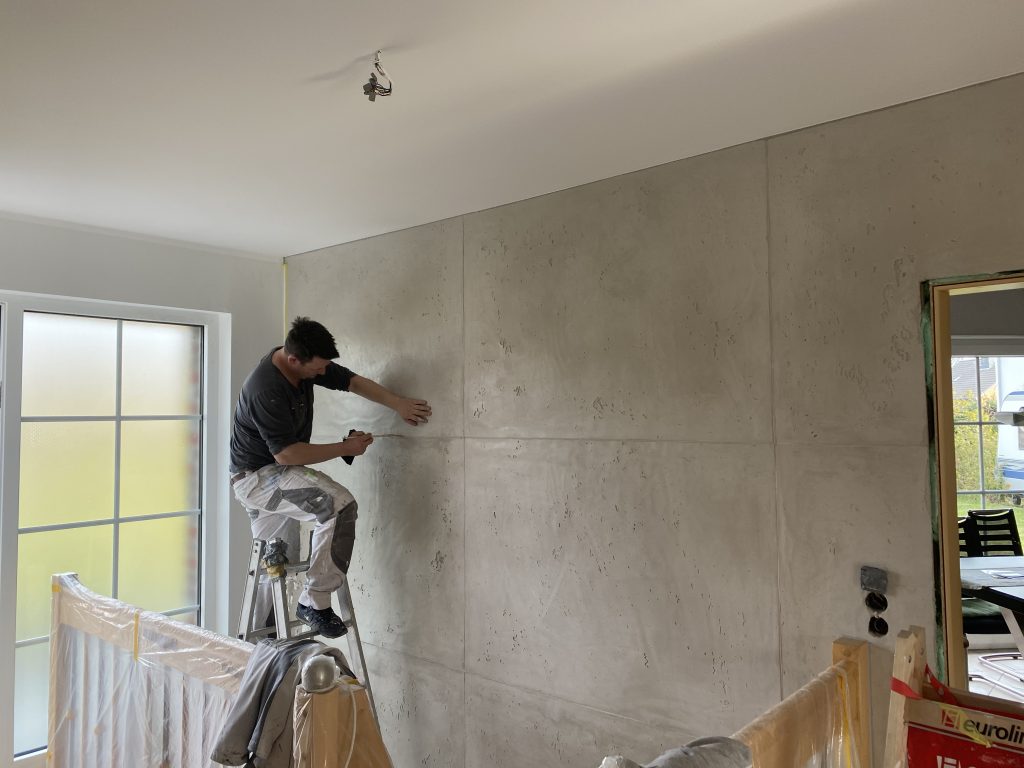 Betonoptikwand in sanften Grautönen mit edler Spachtelstruktur.